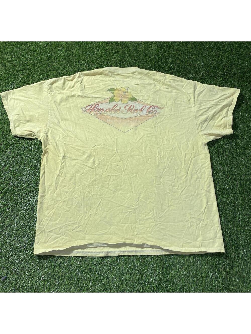 Yellow Hawaiian shirt with floral graphic and 'Hawaiian Surf Co.' text